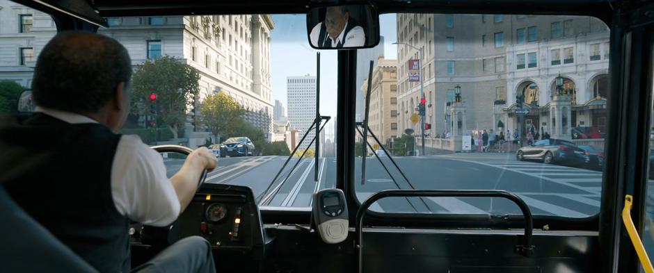 The bus driver struggles to control his bus as it speeds through a red light.