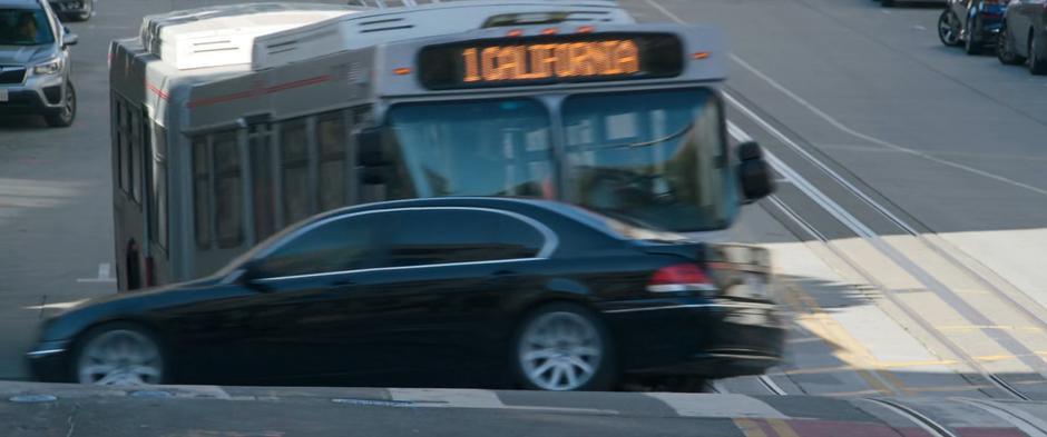 The bus smashes into a car as it speeds through the intersection.