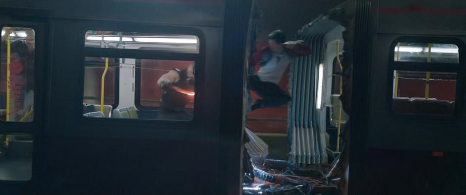 "Shaun" leaps between the nearly separated halves of the bus to kick Razor Fist in the chest.