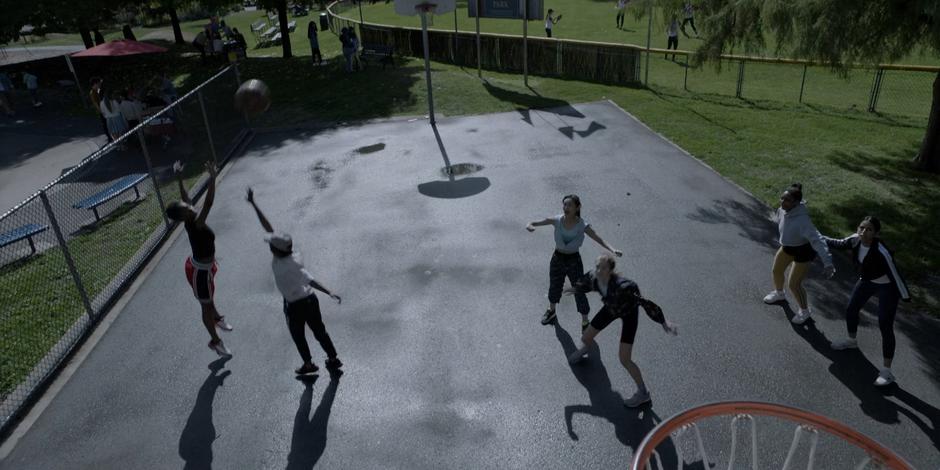 A young woman shoots a basket during the game.