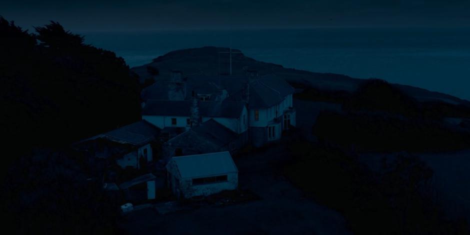 Aerial establishing shot of the house at night.