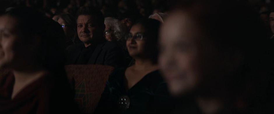 Clint smiles at a young girl dressed like Natasha in the audience.