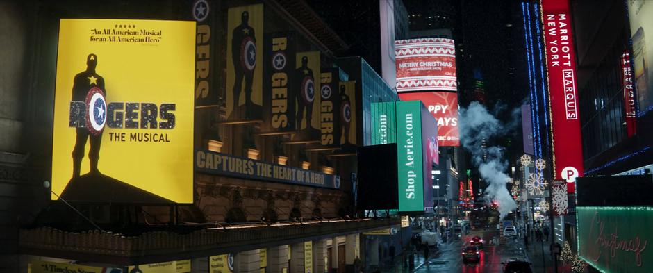 A large screen advertising Rogers The Musical hangs from outside the theater.