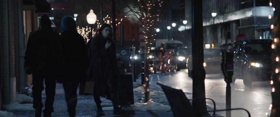 Kate pulls out her phone to call Clint as she walks to the street.