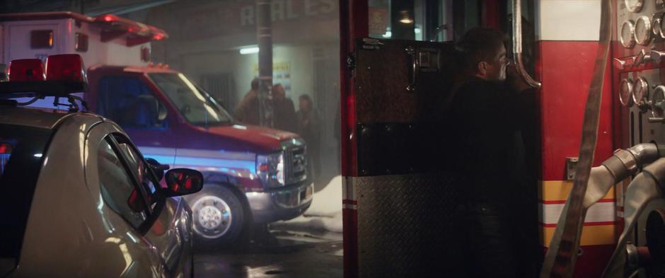 Clint grabs a firefighter disguise from the truck.