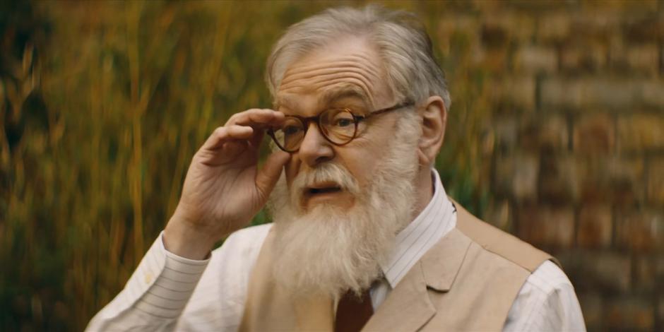 Professor Jericho adjusts his glasses as he examines the writing.