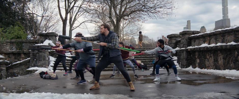 The LARPers run through fight formations in the park.