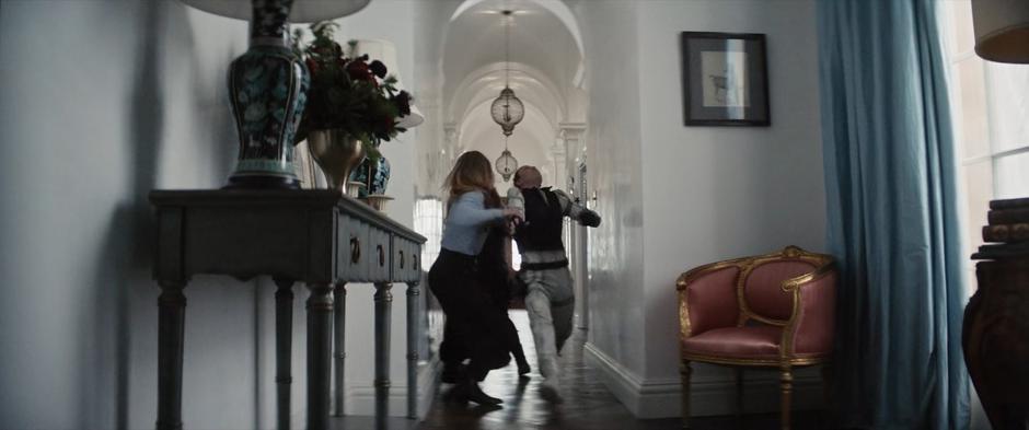 Ana, Sonya, and Yelena fight in the hallway.