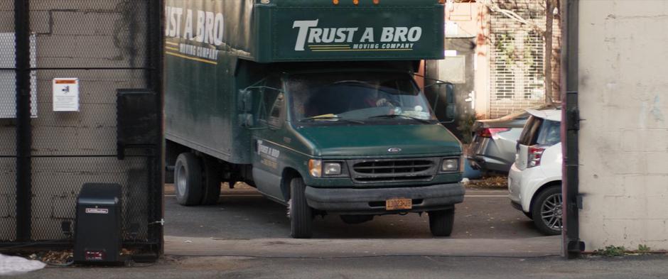 Ivan turns the moving truck into the parking lot.