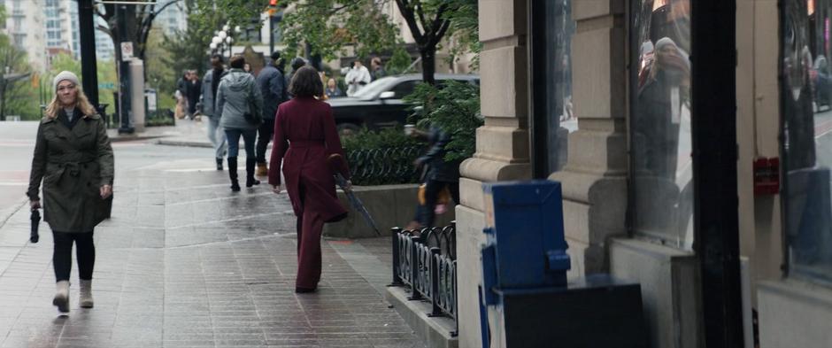 Eleanor turns the corner at the end of the block.