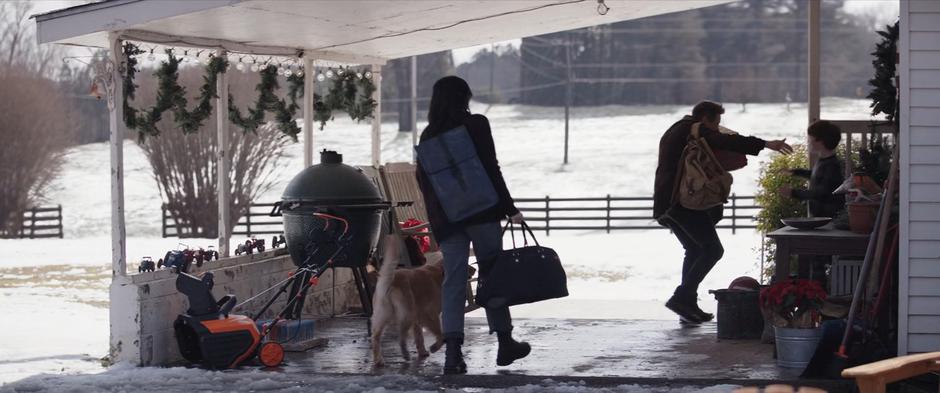 Kate comes up from behind holding Lucky's leash as Clint runs forward to get a hug from Nathaniel.