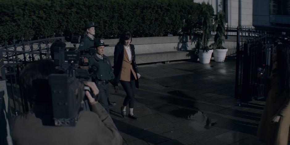 Alice, now Beth, is filmed by news crews as she leaves the courthouse.