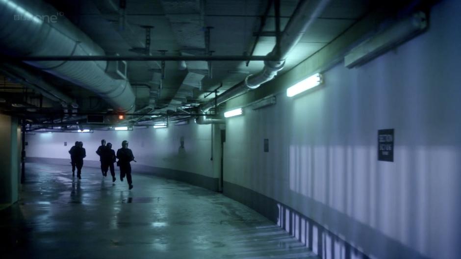 Guards run down the corridor while River gets ready to escape.