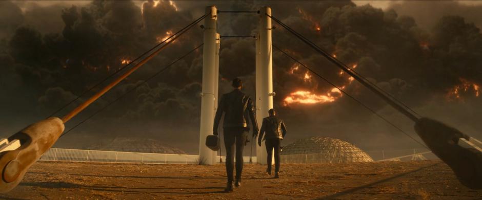 Spock and Pike walk to the transport location as the ion storm looms overhead.