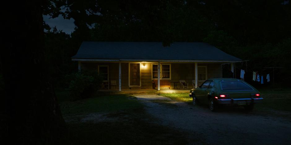 Joyce parks her car in front of the house after work.