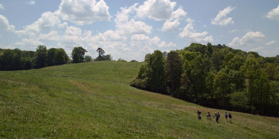 Dustin leads his friends to the top of the steep hill.