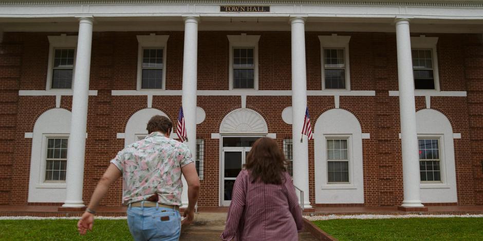 Hopper and Joyce walk up the path to the town hall.