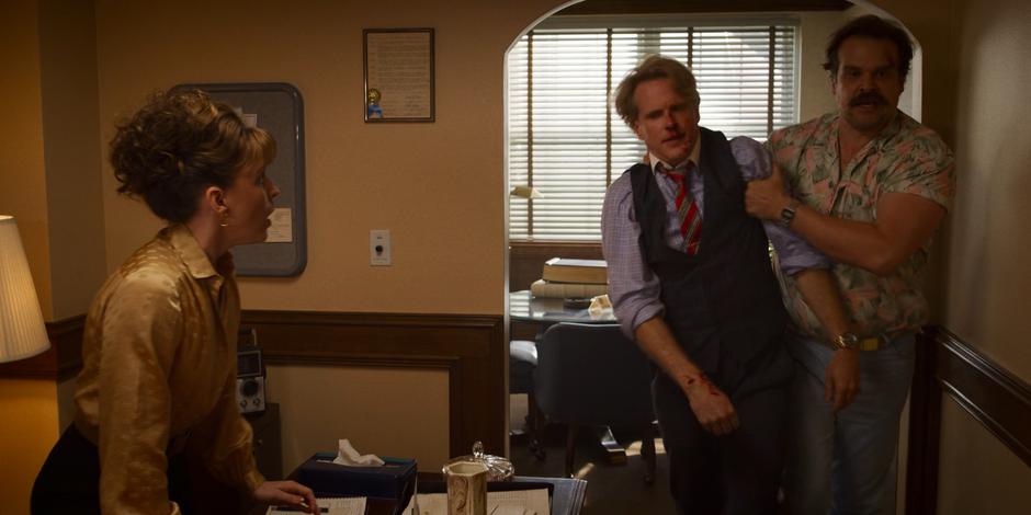 Candice watches as Hopper manhandles Mayor Kline past her desk.