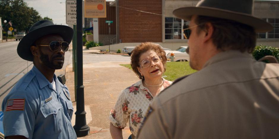 Officer Powell and Florence look at Hopper after he examines his new date shirt.