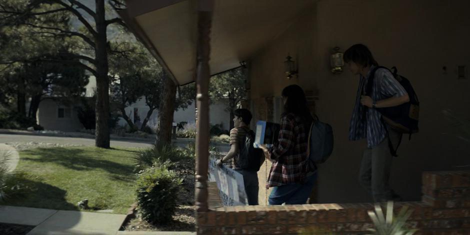 Will, El, and Jonathan exit the house to catch a ride to school.