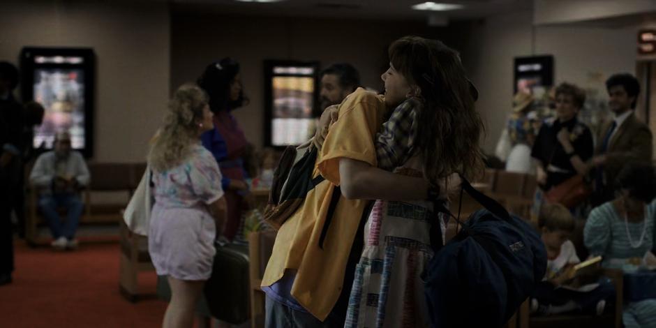 Mike and El hug after he gets off the plane.