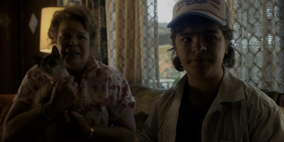 Dustin and his mother Claudia watch the news report on Chrissy's death.