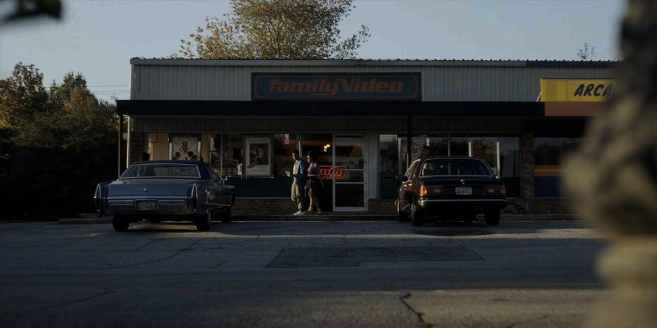 People walk out of the video store after rending a video.