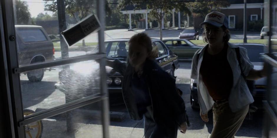 Max and Dustin burst into the video store.