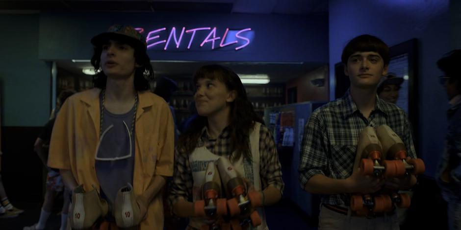 El smiles up at Mike and the two of them and Will walk away from the rentals desk with their skates.