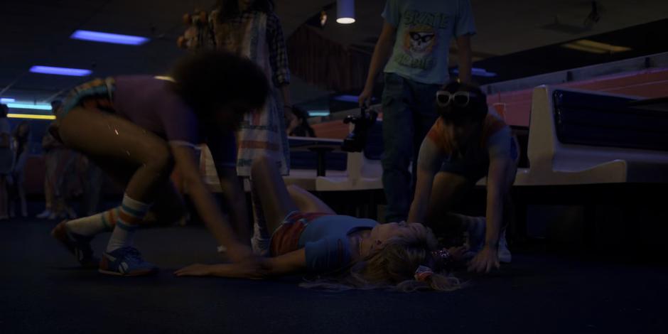 Angela falls to the ground after El hits her with the skate.