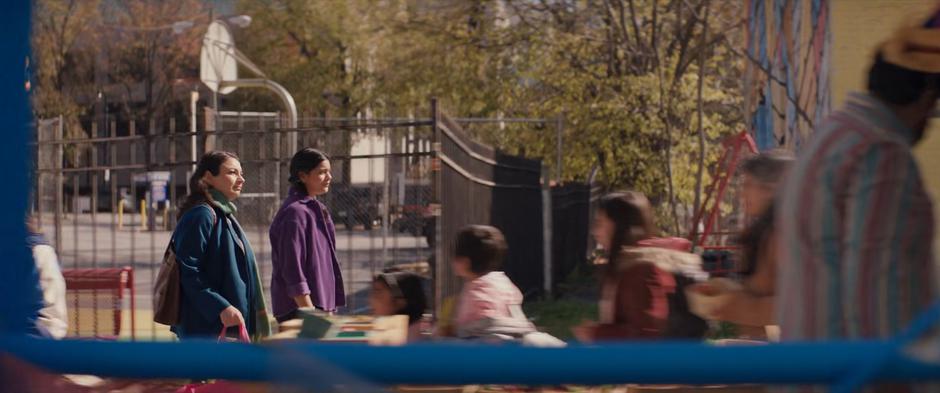 Muneeba and Kamala walk through the busy farmers' market.