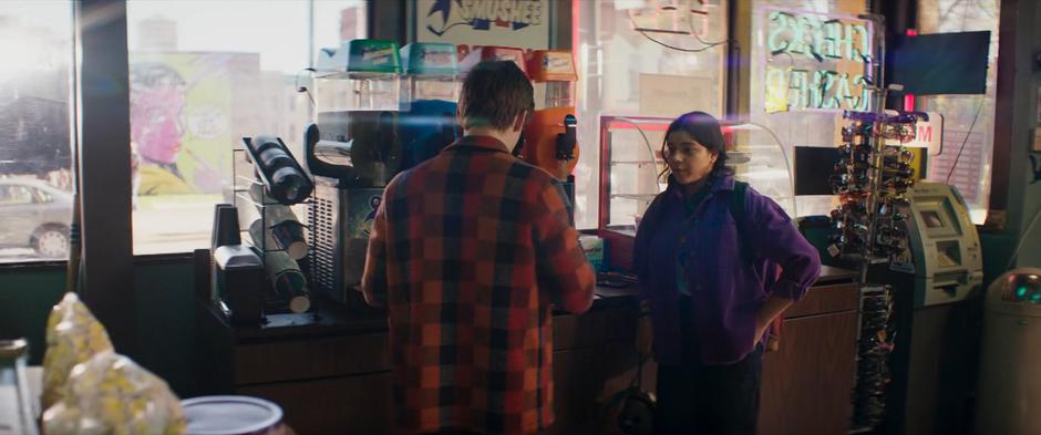 Kamala talks with Bruno who is pouring her a slushie.