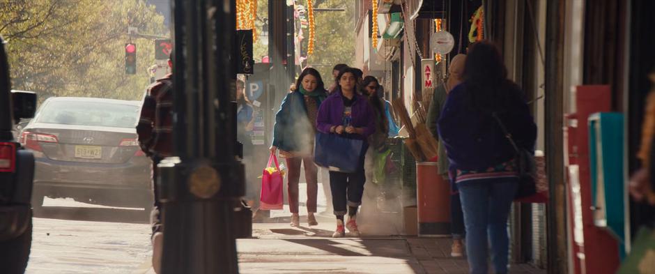 Muneeba and Kamala walk down the sidewalk during their shopping day.