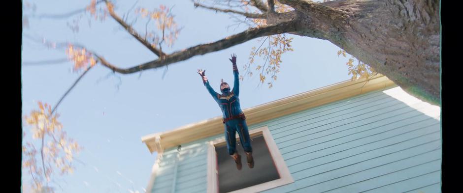 During Kamala's scheme, she gracefully dives out the window towards a branch.