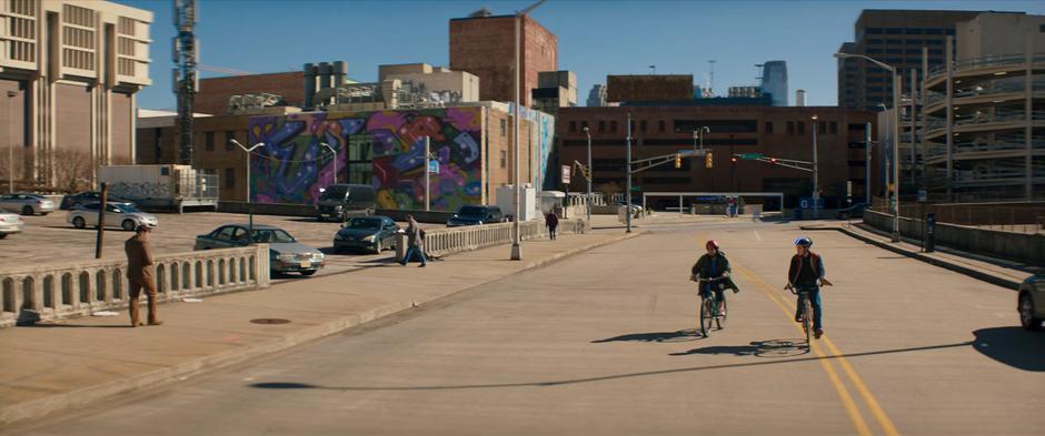 Kamala and Bruno ride down the street to catch their bus.