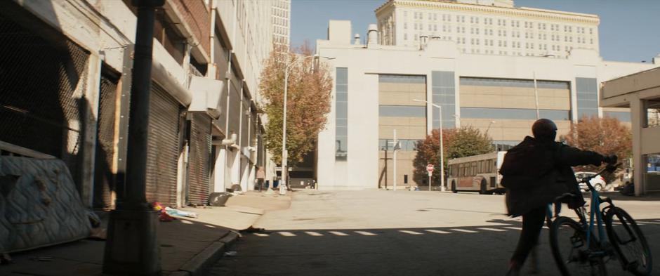 Kamala crosses the street after Bruno to where the bus is stopped.