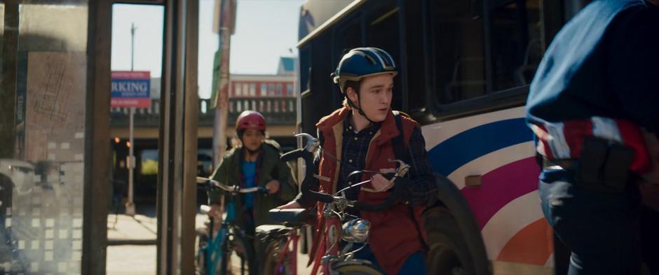 Kamala and Bruno follow another cosplayer onto the bus with their bikes.