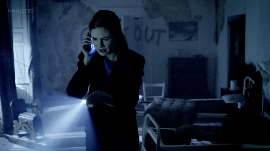 Amy searches through one of the orphanage's bedrooms.