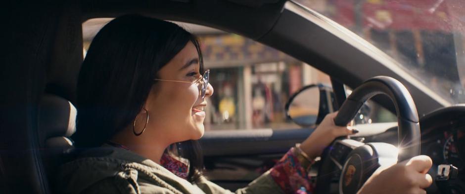 Kamala smiles as she drives Kamran's car down the street.