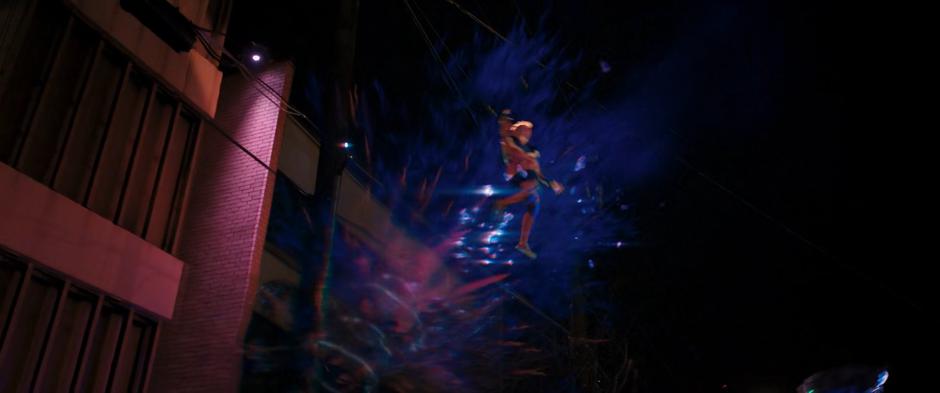 Kamala flies through the air after one of the agents blasts her hard light platform.