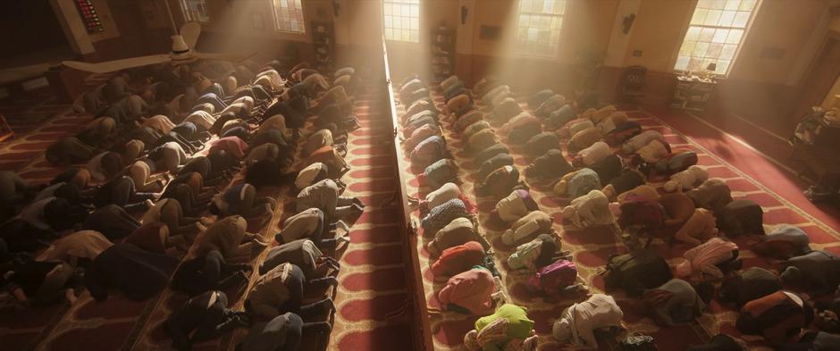 The men and the women pray in the main hall while separated by the partition.