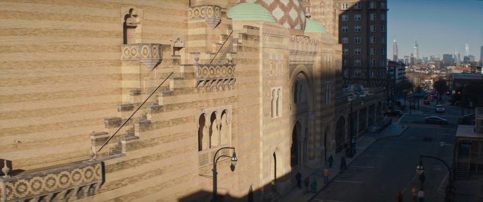 Wide view of the front of the mosque as Kamala and Nakia race.