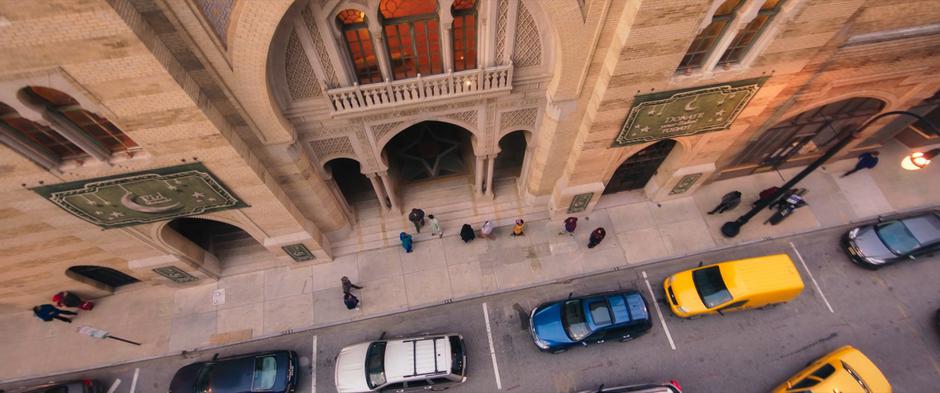 Establishing shot of the mosque entrance which is hung with Eid banners.