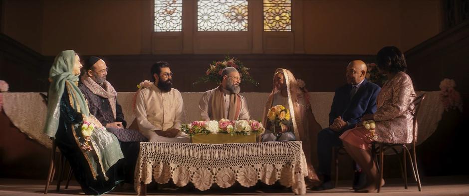 Sheikh Abdullah performs the marriage ceremony for Aamir and Tyesha on the stage surrounded by their parents.