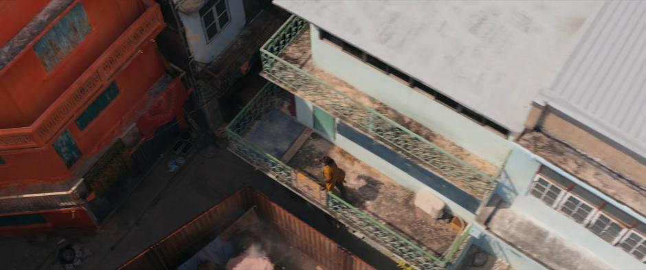 Waleed runs across another balcony towards the alley.