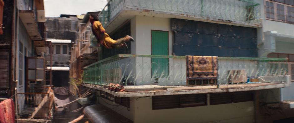 Waleed leaps from one balcony to another across the alley.