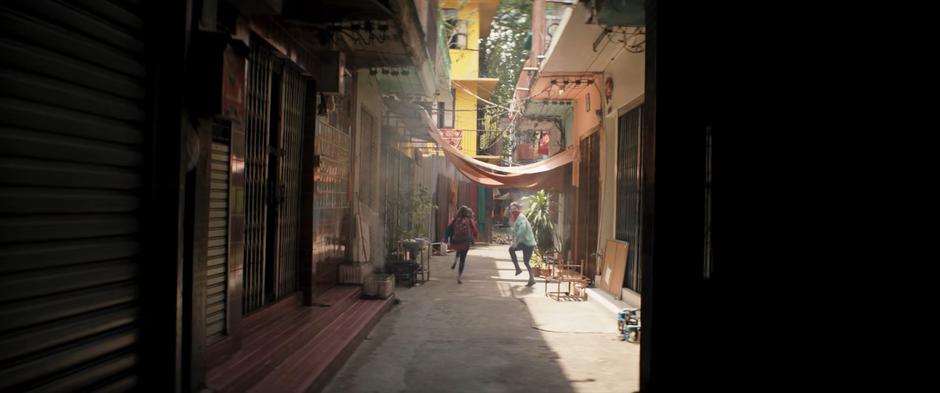 Kamala and Kareem race down the alley.