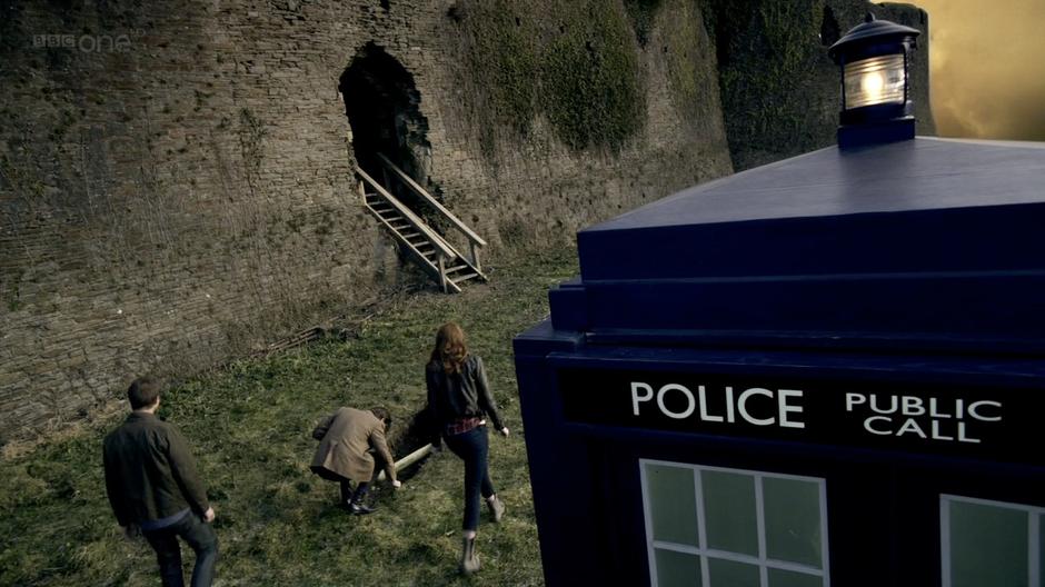 The Doctor examines an exposed acid pipe after landing in the TARDIS.