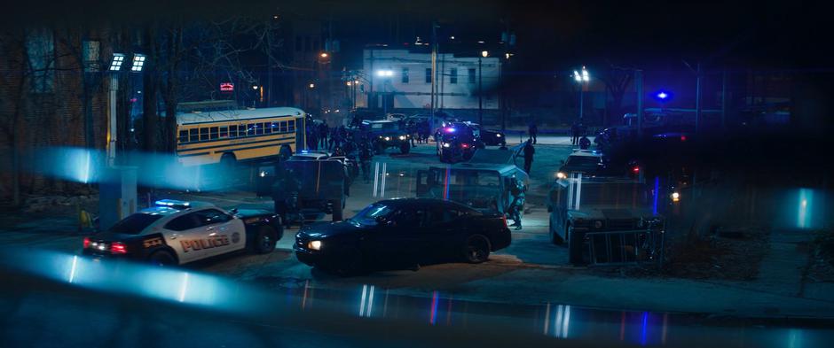 The police and DODC gathering in the parking lot is visible through the window.