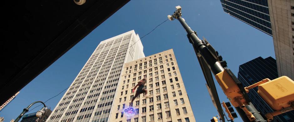 Kamala continues leaping through the intersection after the light turns green.